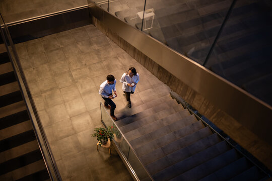 Business people walking on office stairs during break