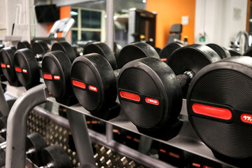 dumbells on a rack, in a leisure gym