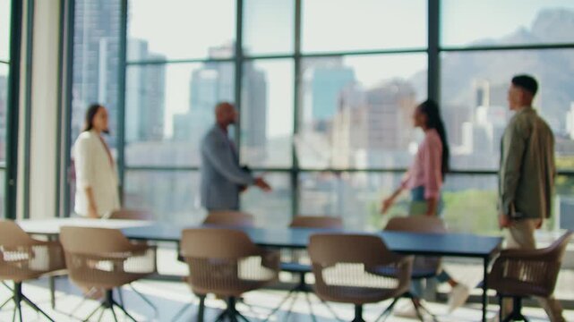 Blurred diverse business people greeting each other in meeting room at office during daytime