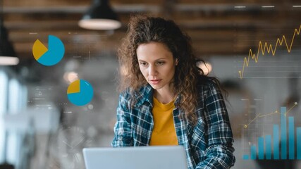 Marketer personalizing campaign tactics by integrating CRM data and survey results using a laptop in a creative workspace with charts displayed.