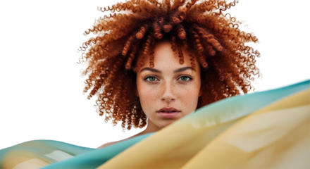Close-up of the face of a red-haired woman with curly hair, a cloth billowing in the wind.
