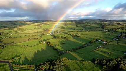 Aerial footage of rainbows over fields
