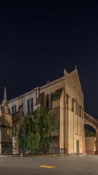 Cathedrale Saint-Andre de Bordeaux night timelapse hyperlapse with twin spires. Illuminated buildings and trees on the Pl. Pey Berland square create an evening urban atmosphere. Bordeaux, France