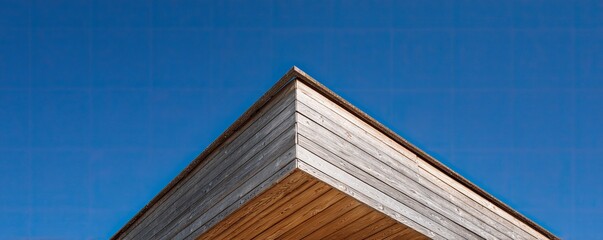 Wooden building corner against a clear blue sky (8)