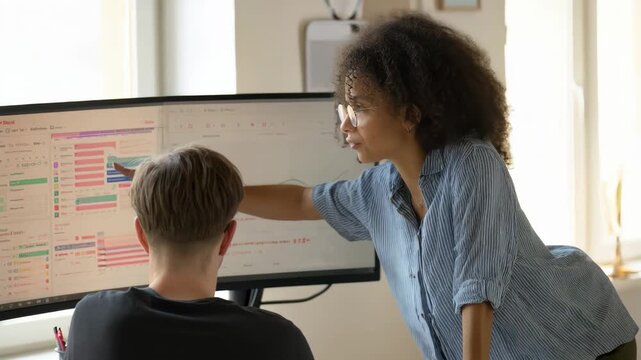 Medium shot of an HR representative guiding a new recruit through a digital onboarding dashboard reviewing schedules policies and personalized welcome messages online.
