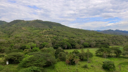 Fototapeta premium Drone view of the rolling hills and fragmented green landscape of the Tropical Dry Forest (Bosque Seco Tropical) near Apulo, Cundinamarca, Colombia.
