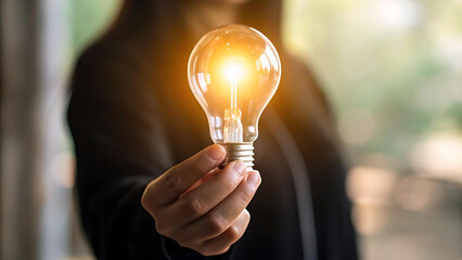 Captivating lightbulb held by a person, radiating brilliance, symbolizing innovation and bright ideas for business success and problem solving solutions