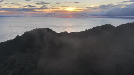 A peaceful dawn illuminates the island of Nusa Laut just east of Ambon, Indonesia. This beautiful, tropical island is a popular destination for diving and snorkeling.