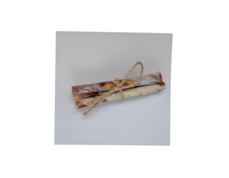 Bundled and tied rawhide sticks for dogs with twine against isolated gray background