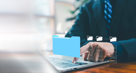 Business professional organizing digital folders on a laptop, representing efficient file management, data organization, cloud storage solutions, and streamlined workflow processes in a modern digital