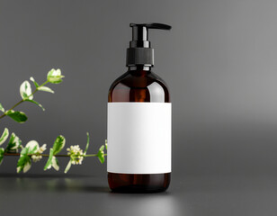 Minimalist dark glass cosmetic dispenser bottle with blank label against a dark background & green leaf accent. Perfect for beauty/skincare branding.