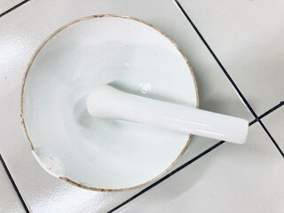 top view of white mortar and pestle on laboratory bench