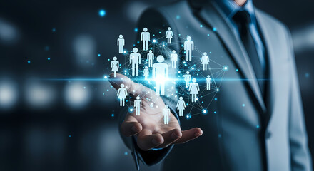 A businessman's hand holds a glowing network of people, representing human resources and business connections in a digital world.