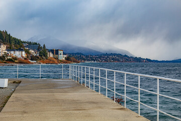 Obraz premium view from the pier San Carlos de Bariloche, Civic Center, Patagonia Argentina glacial lake Nahuel Huapi, next to the Andes Mountains 