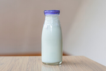 ガラス瓶に入ったミルク　木のテーブルに置かれた飲み物