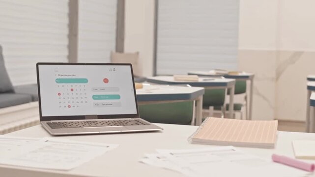 Empty Classroom Scene with Papers, Laptop, and Schedule in Motion