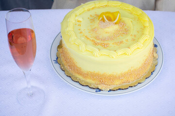 Hand grabbing a yellow lemon buttercream frosting birthday cake