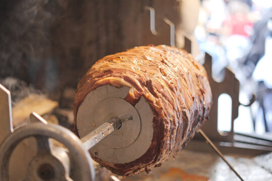 Juicy meat on a spit roaster at a street food market