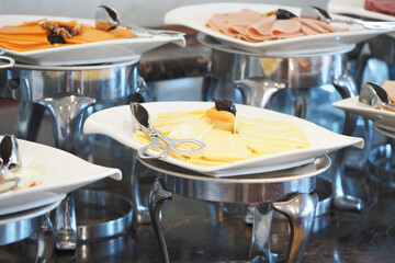 Cheese and cold cuts display in a buffet setting