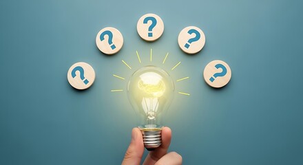 Hand holding a light bulb surrounded by question marks on wooden circles