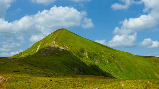 green lonely mount on a dense clouds background, Ukraine, Carpathians, Hoverla mount time lapse scene