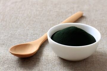 Spirulina Powder in Small Dish with Spoon for Healthy Superfood Ingredient Photography Nutrition Inspiration