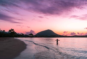 Greeting the Sunrise at Kuliouou Beach Sunsrise in Hawaii Kai, Oahu, Hawaii, USA