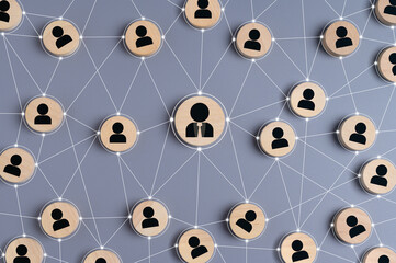 Abstract representation of business network, social connections, or teamwork with wooden circles featuring user icons linked by lines. concept of communication, hierarchy, leadership, and community.