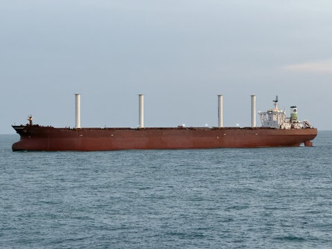 Valemax class ultra-large ore carrier, a true titan of the sea. green transition. wind-assisted propulsion system integrated into the deck&mdash;towering rotor sails that utilize the Magnus effect.
