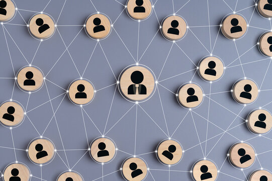 Abstract representation of business network, social connections, or teamwork with wooden circles featuring user icons linked by lines. concept of communication, hierarchy, leadership, and community.