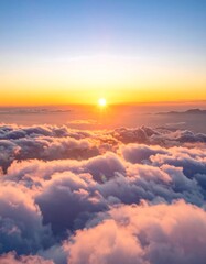 A captivating sunrise illuminates fluffy, layered clouds from above, creating an ethereal panorama with warm oranges and blues