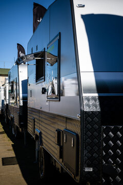 A line of caravans at an outdoor motorhome show - vertical
