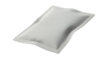 A white pillow lies flat on a plain white surface viewed from above softly