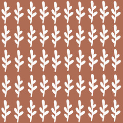 Repeating leaf pattern background. Seamless pattern of white leaves on a brown background.