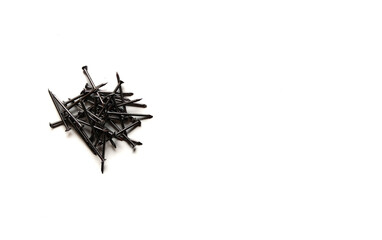 A pile of small steel nails isolated on a clean white background. Minimalist construction and hardware concept suitable for product mockup, DIY tools, or repair themes.