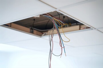 exposed electric wire hanging from broken ceiling
