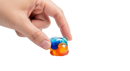 A person's hand holds a single, colorful laundry detergent pod between their thumb and forefinger against a white background.