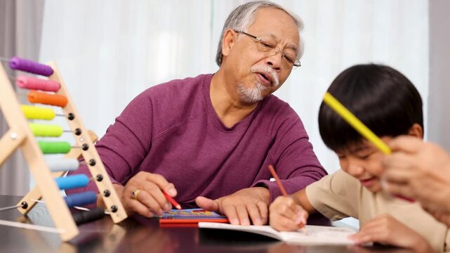 Grandfather Teaching Grandson with Abacus at Home Table