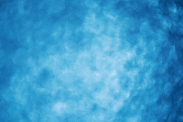 Abstract blue defocused light background with vignette.