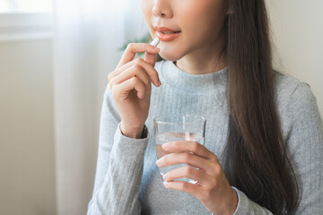 Dietary supplement, healthy diet positive asian young woman hand holding pill capsule, take vitamin...