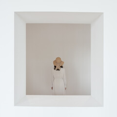 Minimalist Portrait of a Woman in a Hat Inside a White Frame