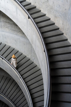 Elegant Spiral Staircase with a Woman in a Hat