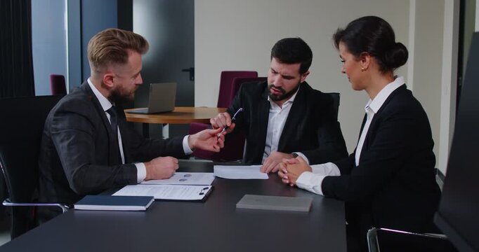 Group of business people pose at office desk, reaching agreement and signing contract, discussing new project. Family lawyer helps clients with consultancy. Legal experts in business 