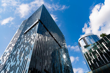 Obraz premium Architecture office building. Perspective skyscraper. Minimalist glass architecture. Business skyscraper building. Architectural building business area. Glass skyscraper. City metropolis architecture