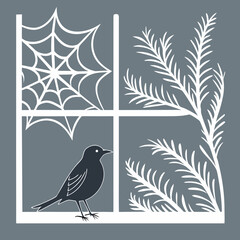 A black bird perched on a window with a spiderweb and branch silhouette