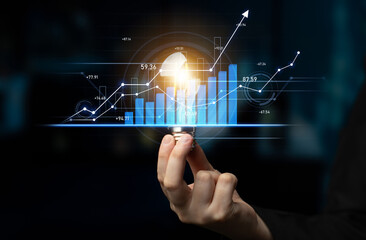 A conceptual image illustrates a hand holding a glowing light bulb amidst digital data charts, symbolizing innovation, growth, and technology in a modern business environment. Scalp