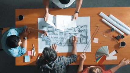 Time lapse of smart architect engineer team talking about project plan while manager walking at meeting table and start working and analyze building construction and looking at blueprint. Symposium.