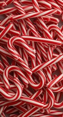 A vibrant pile of traditional peppermint candy canes displays classic red and white stripes, perfect for seasonal decorations and winter treats ,dessert ,treats ,greeting