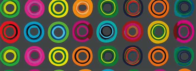 Wzorzyste, wielokolorowe okręgi tworzą dynamiczną, nowoczesną teksturę na ciemnym tle.