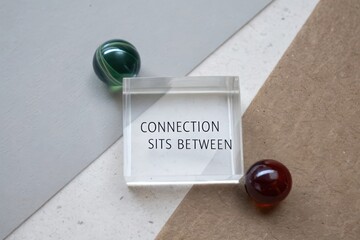 Transparent block displaying connection text between two marbles